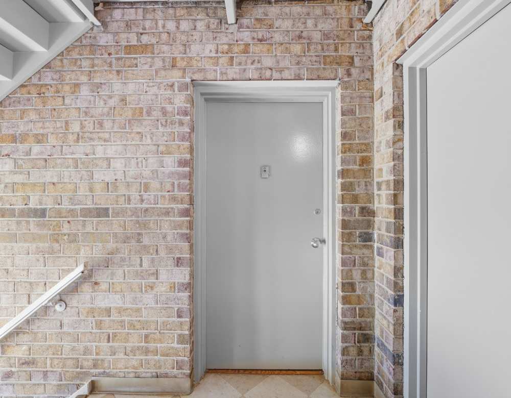 White door with brick wall backdrop at Fairway Apartments in Reston, Virginia