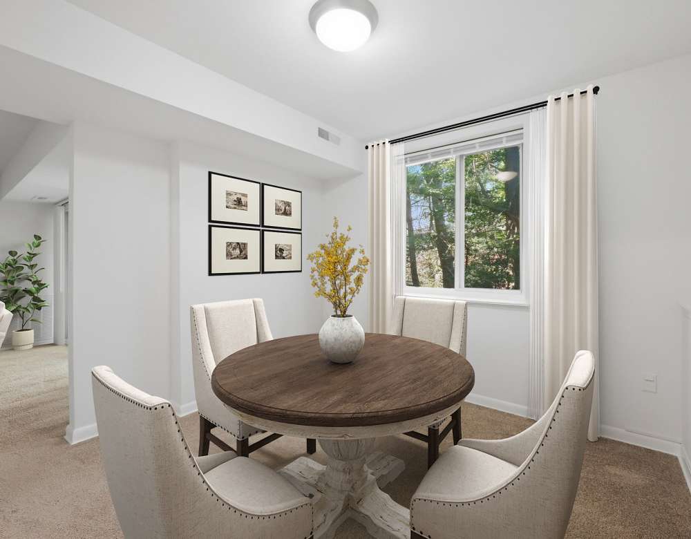 Carpeted living area with balcony view at Fairway Apartments in Reston, Virginia