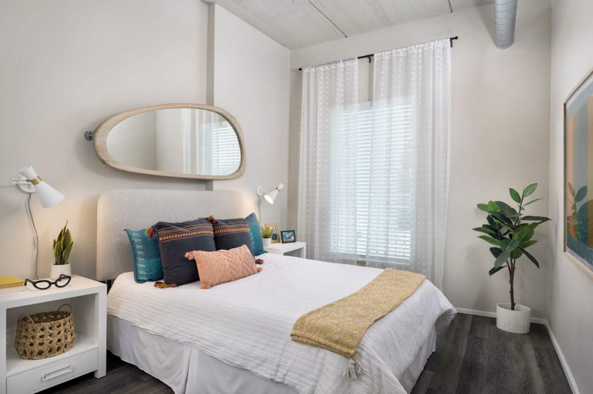 Well-lit bedroom with a comfortable bed at RainDance in Winter Haven, Florida 