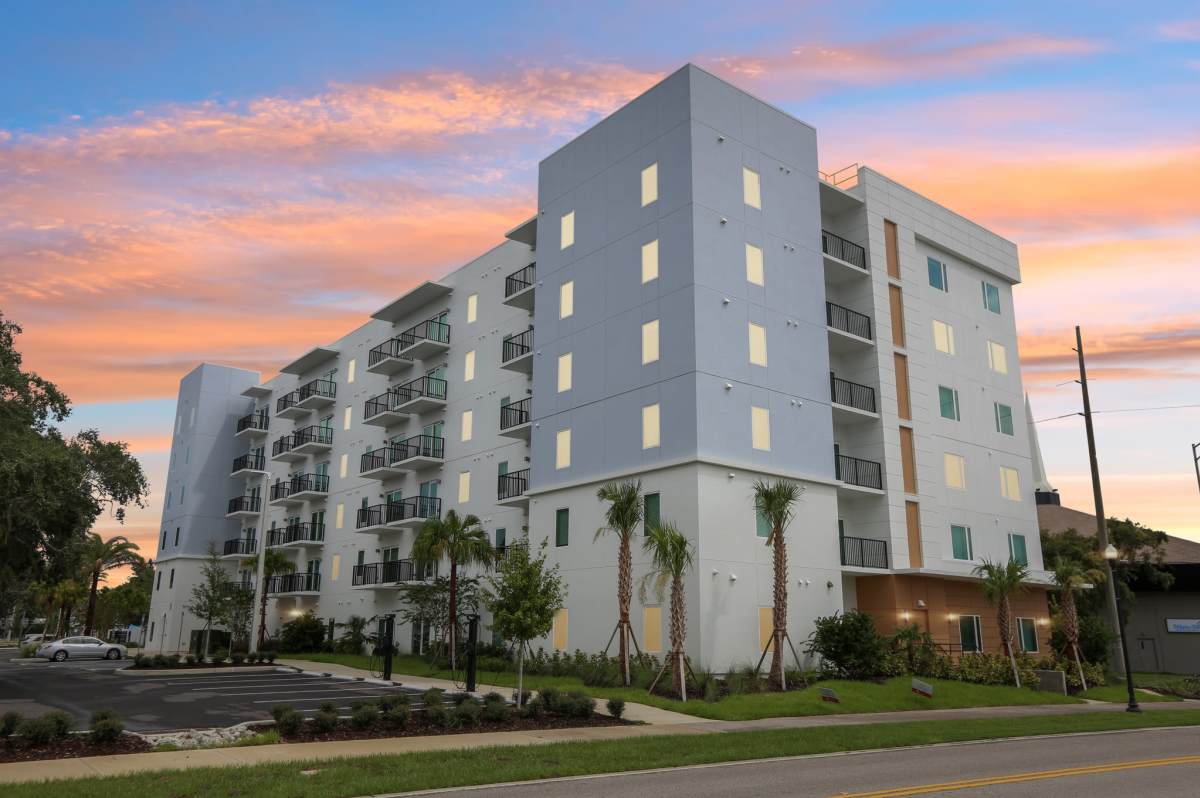 Community building exterior view in the evening at The Breeze in Winter Haven, Florida