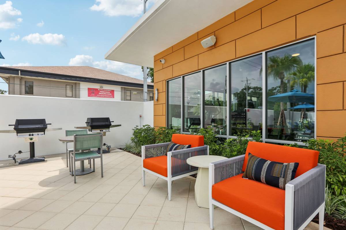 Outside seating area with grilling station at The Breeze in Winter Haven, Florida