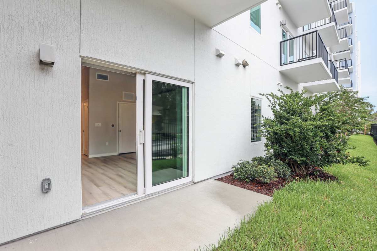 Community backyard with grass lawn at The Breeze in Winter Haven, Florida