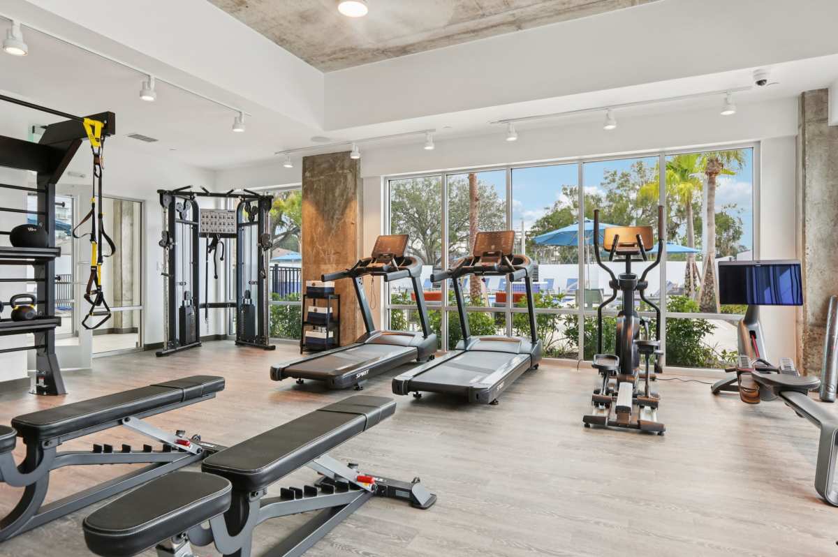 Fitness center with full height window at The Breeze in Winter Haven, Florida