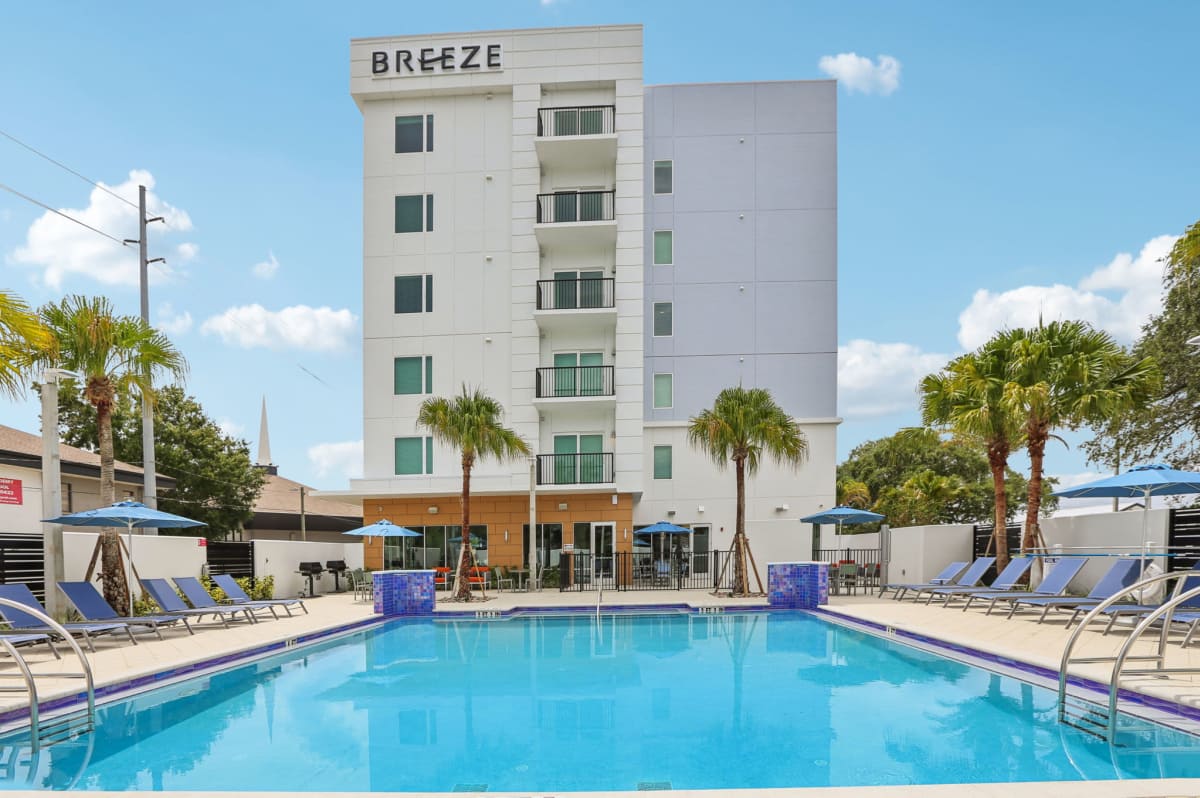 Pool with lounge chairs at The Breeze in Winter Haven, Florida