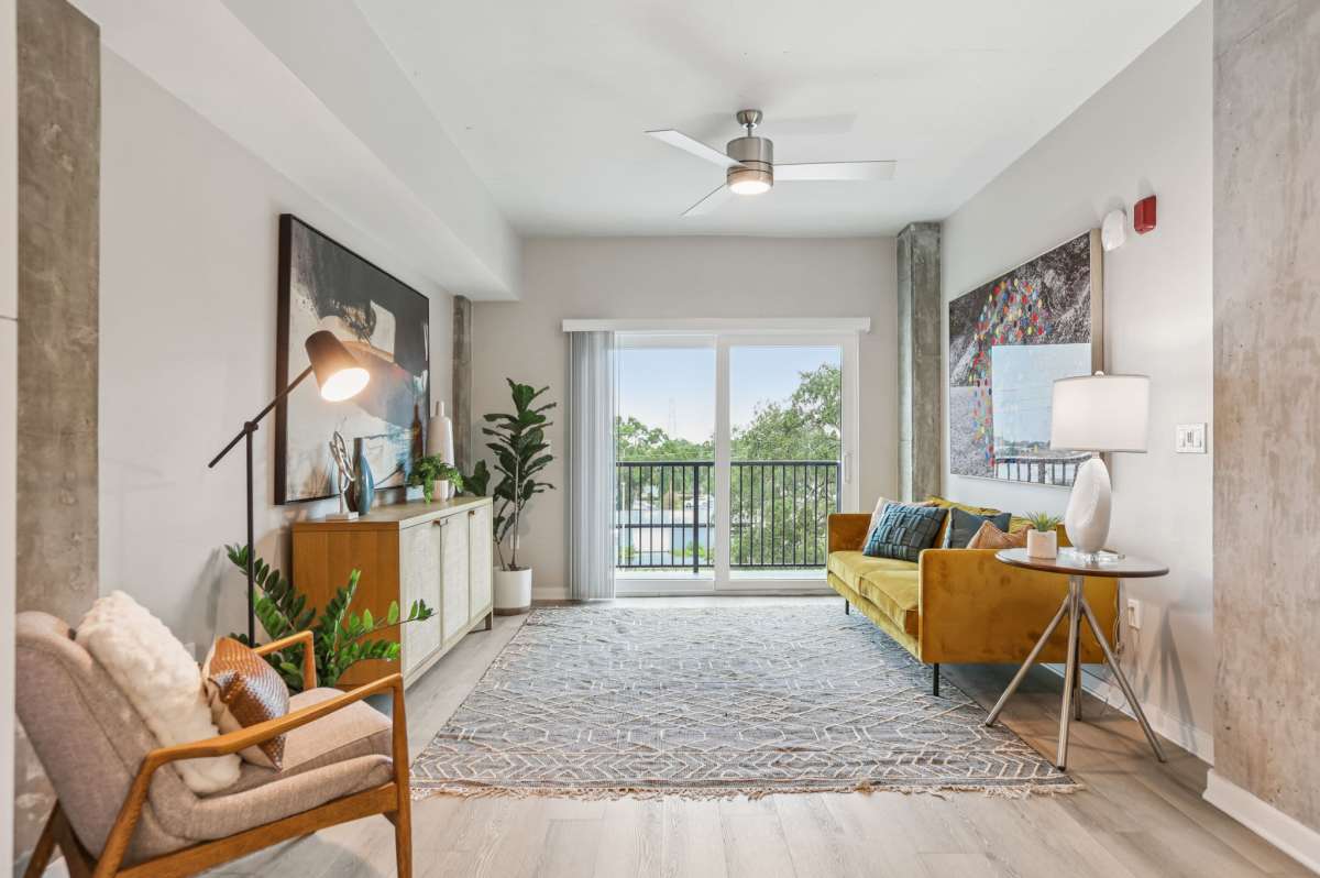 Living room with large rug and sofa at The Breeze in Winter Haven, Florida