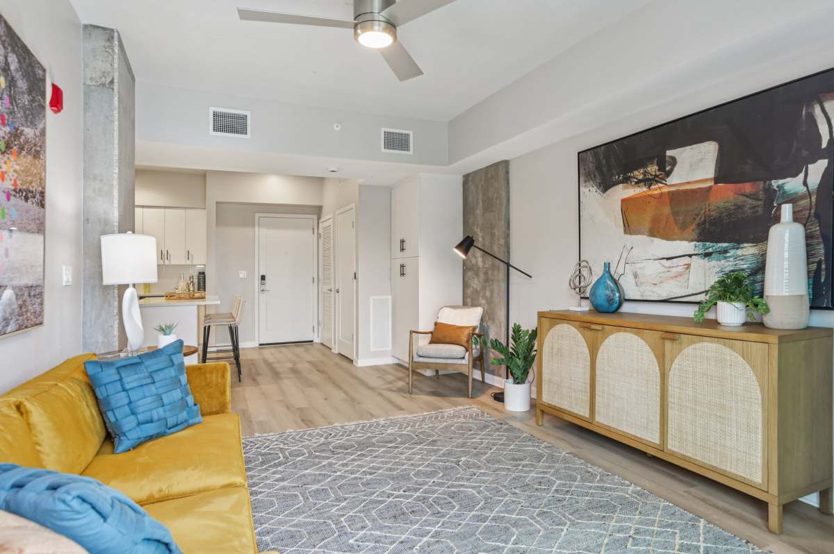 Living room with beautiful wall art at The Breeze in Winter Haven, Florida