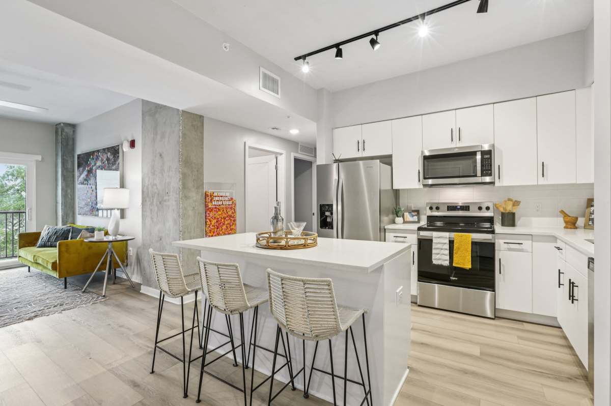 Kitchen with breakfast island and barstool at The Breeze in Winter Haven, Florida