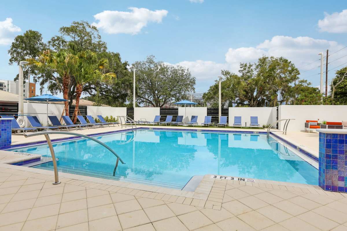 Pool with lounge chairs at The Breeze in Winter Haven, Florida