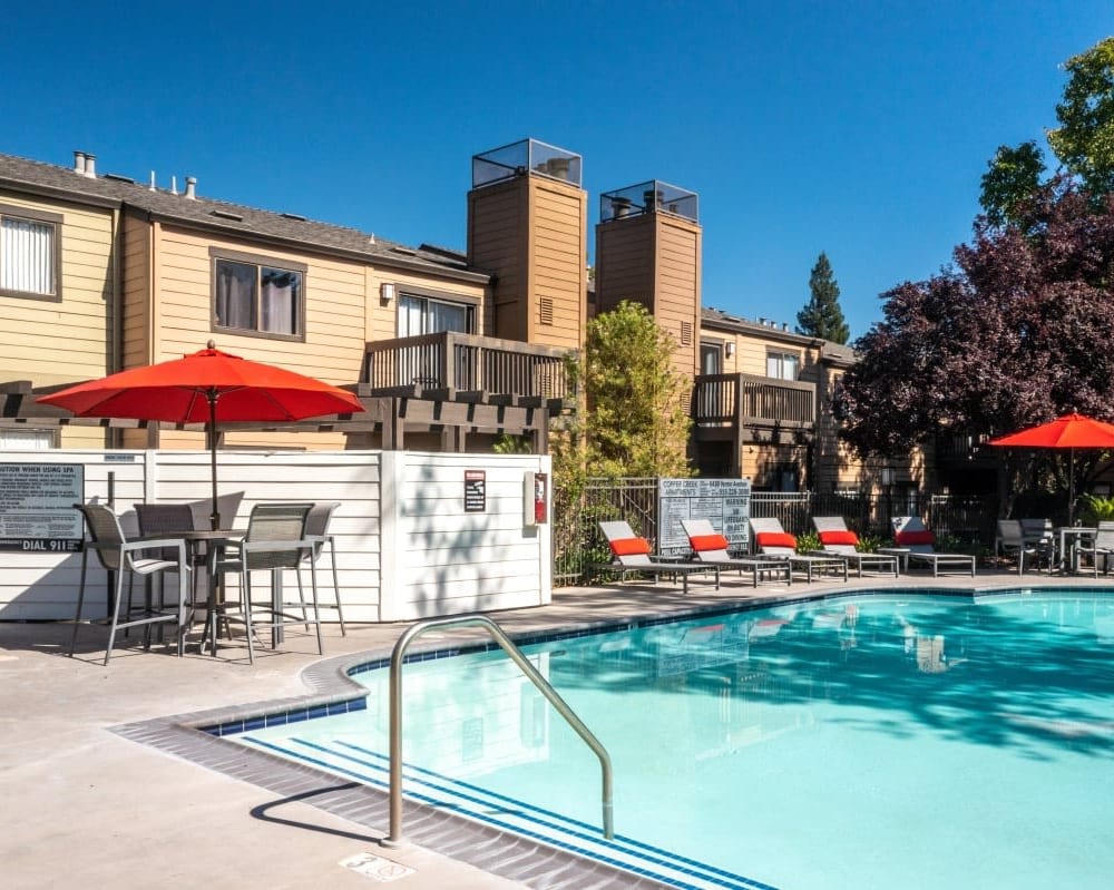 Lounge chairs by the resort-style swimming pool at Copper Creek in Sacramento, California