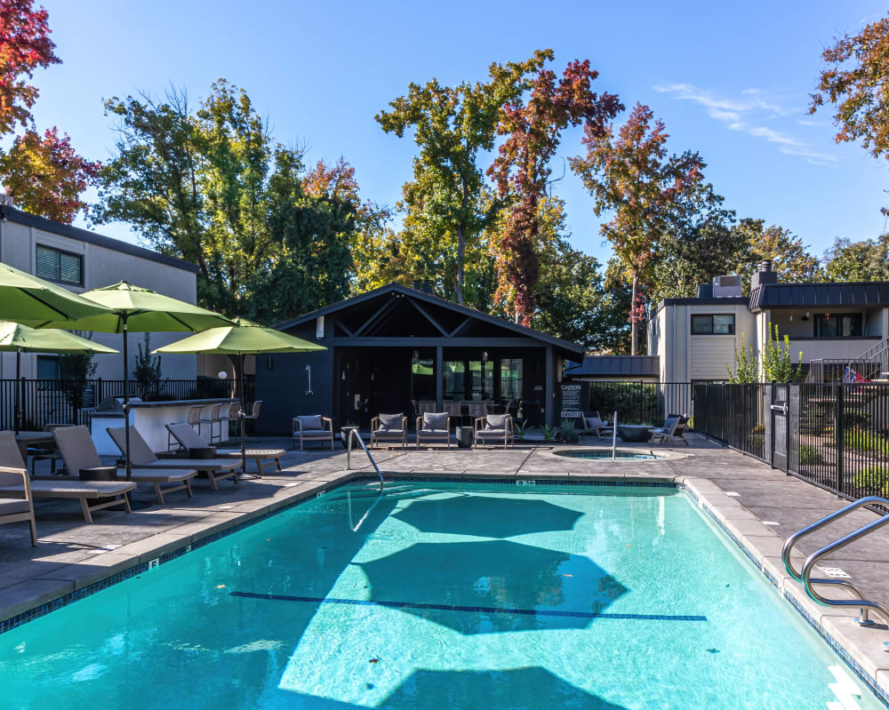 Swimming pool with shaded seating at Terra Vida in Carmichael, California