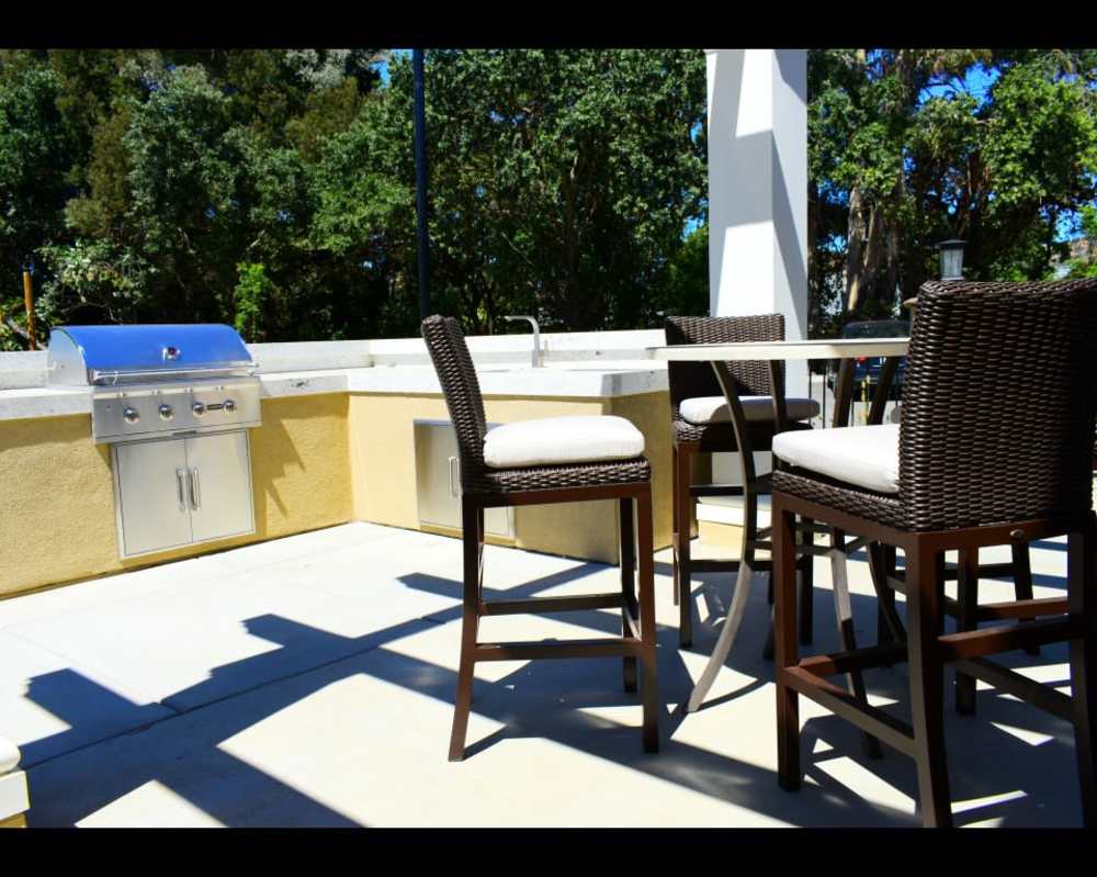 Grilling area with seats and table at Vines on 80 in Fairfield, California