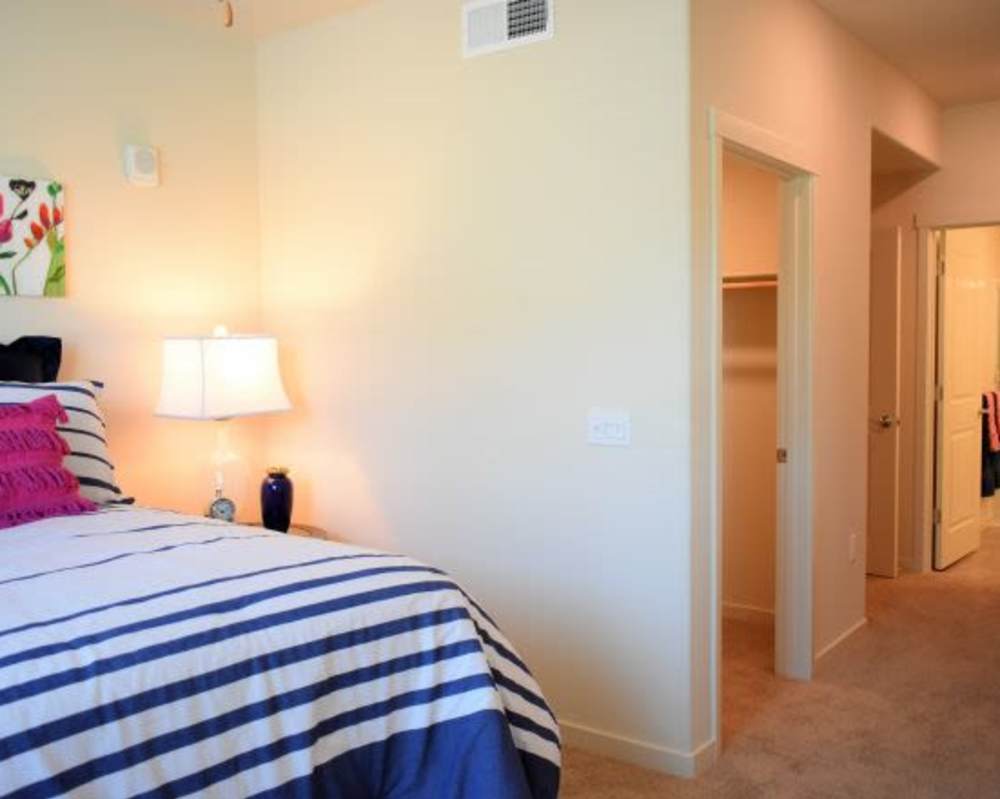 Bedroom with side lamp at Vines on 80 in Fairfield, California