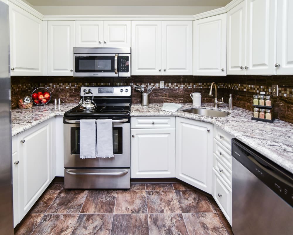Fully equipped kitchen with white cabinetry and stainless steel appliances at Abrams Run Apartment Homes in King of Prussia, Pennsylvania