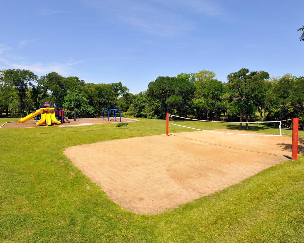 Playground and sand volleyball court at Carrollton Park of North Dallas 