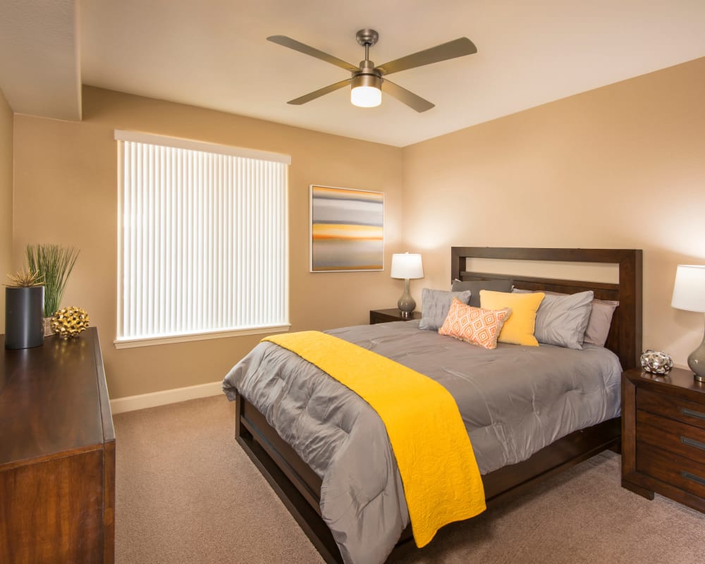 Bedroom with lighted ceiling fan at Southern Avenue Villas in Mesa, Arizona