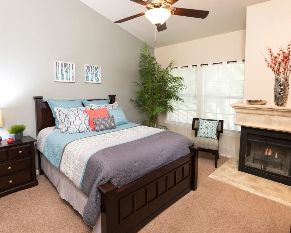 Bedroom with fireplace at Villas at Parkside in Farmers Branch, Texas