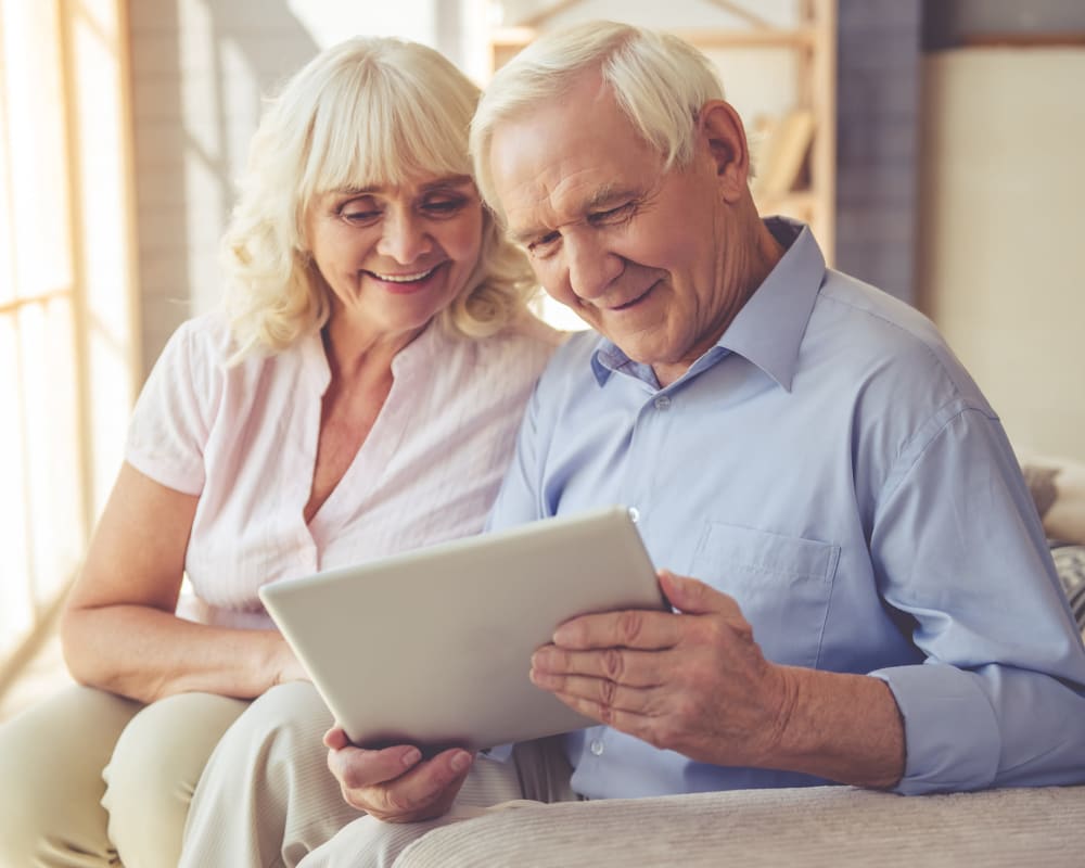 A resident showing a photo to another resident at Welbrook Grand Montecito in Las Vegas, Nevada