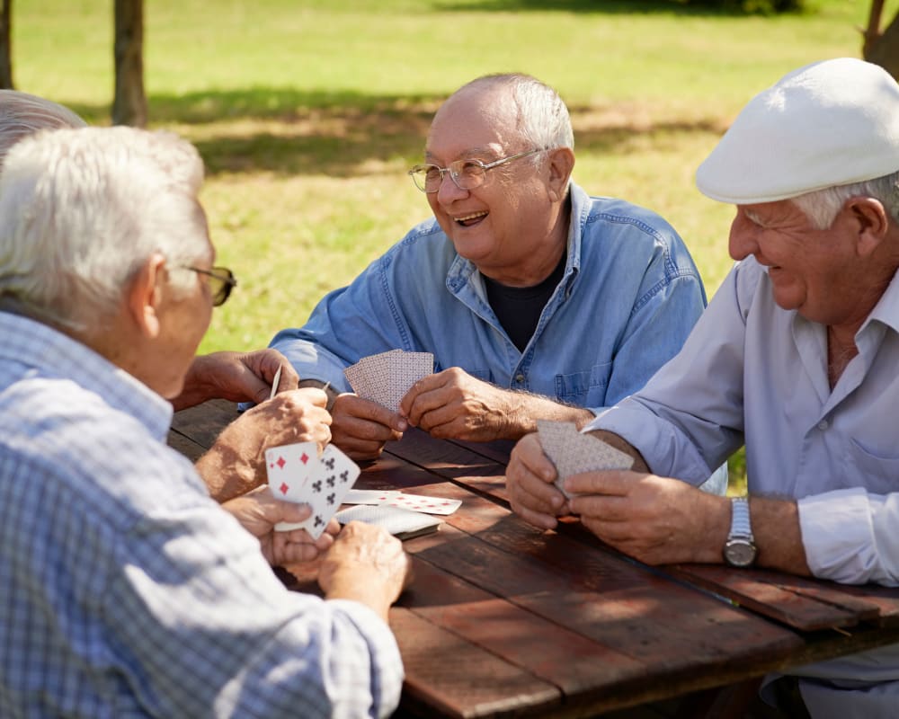 Senior men playing cards at Welbrook at Bloomington in Bloomington, Illinois