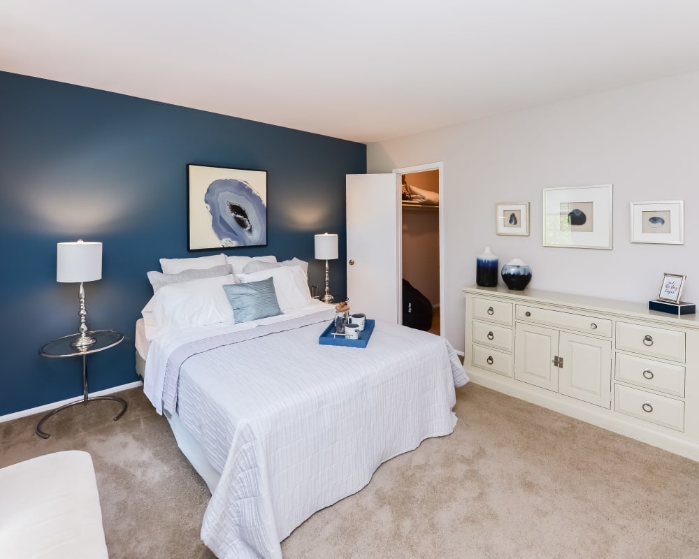 Model bedroom with a blue accent wall at Brookside Manor Apartments & Townhomes in Lansdale, Pennsylvania