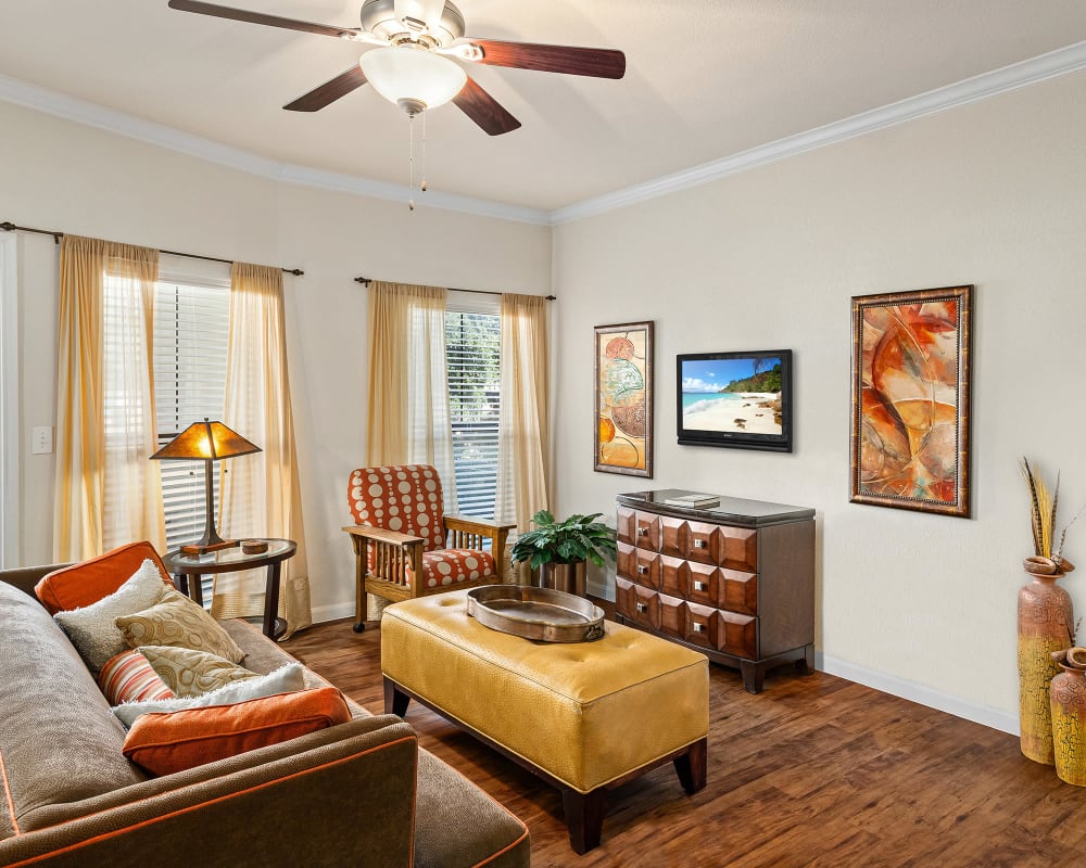 Living room with ceiling fan at Onion Creek Luxury Apartments in Austin, Texas
