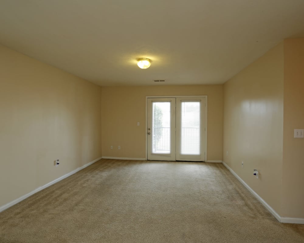 Spacious living room with a doors to the balcony at Ashton Park Apartments in Gulfport, Mississippi