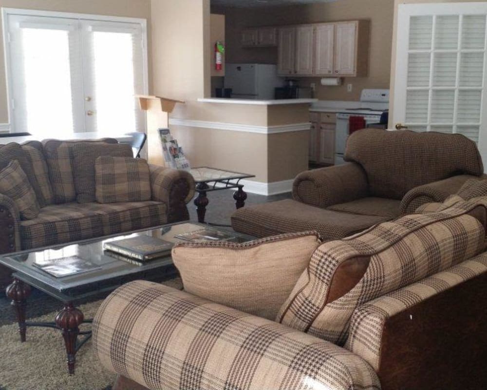 Comfortable seating and an open kitchen in the clubhouse at Bristol Park Apartments in Jackson, Mississippi