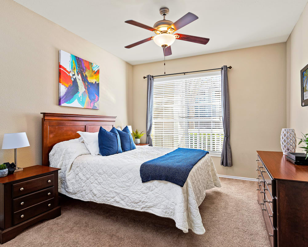 Bedroom with ceiling fan at The Lodge at Shavano Park in San Antonio, Texas