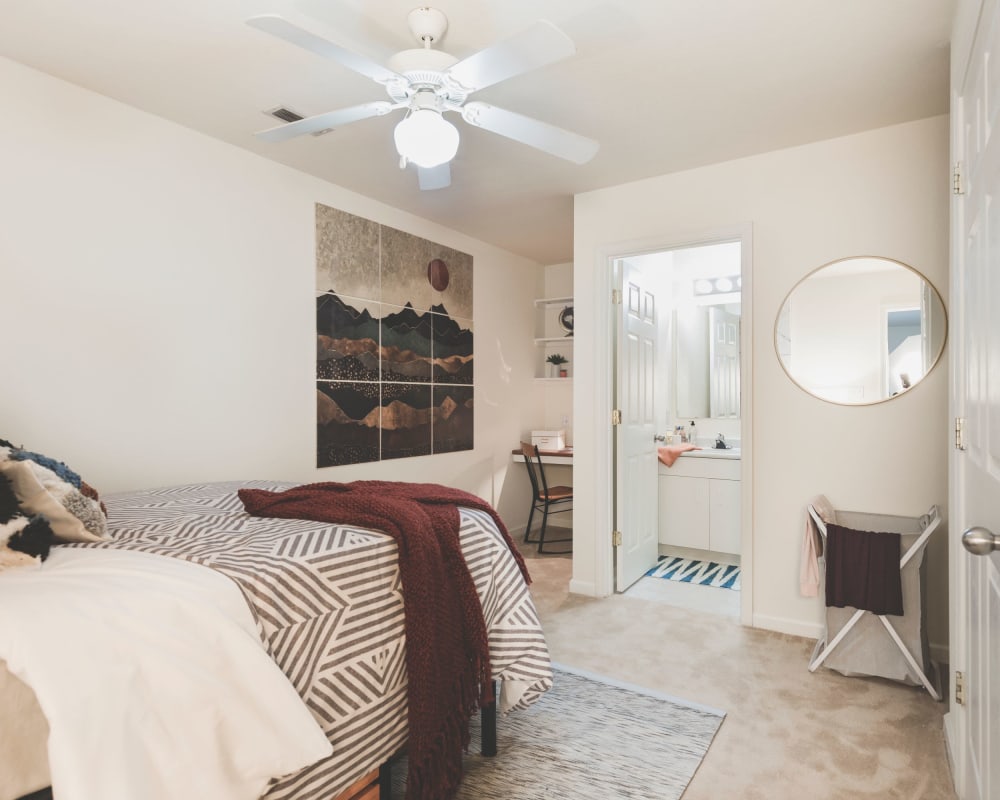 Spacious master bedroom with plush carpeting at Sunchase Apartments in Greenville, North Carolina