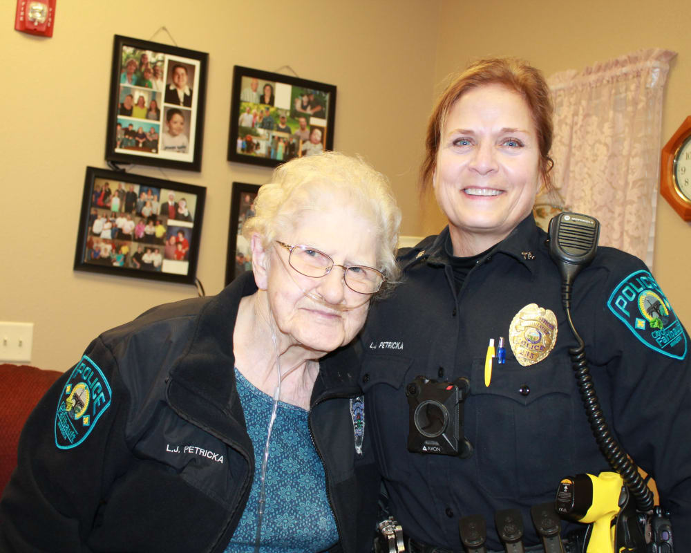 Resident Georgie with local police for her dare to dream event from Milestone Senior Living in Faribault, Minnesota.