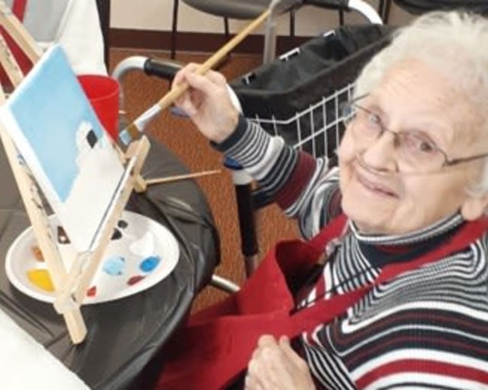 Resident Violet painting a picture for her dare to dream event from Milestone Senior Living Woodruff in Woodruff, Wisconsin.