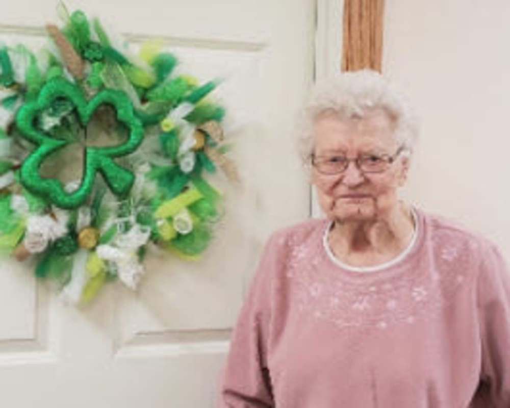 Resident Leona standing next to the wreathe she made for her dare to dream event from Addington Place of Carroll in Carroll, Iowa.