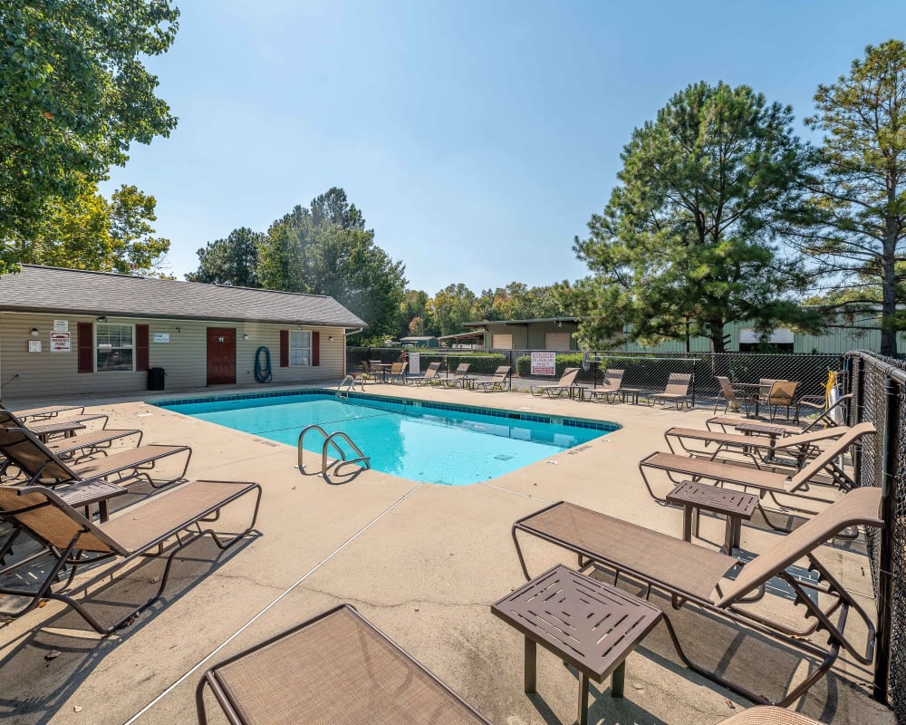 Swimming pool with a large sundeck and lounge chairs at Waters Edge Apartment Homes in Concord, North Carolina