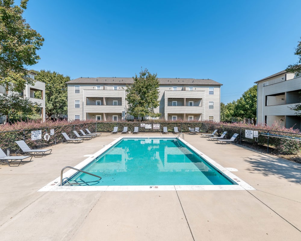 Swimming pool with poolside lounge chairs at The Village at Brierfield Apartment Homes in Charlotte, North Carolina