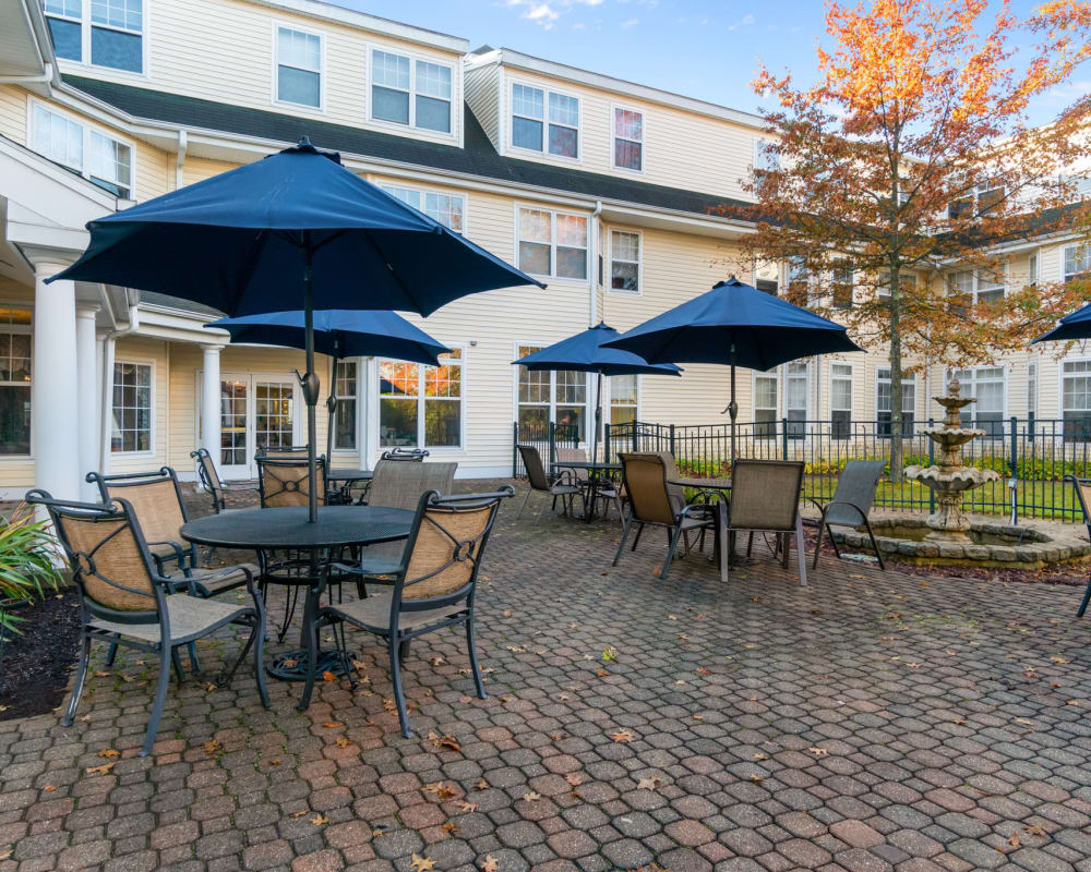 Brick patio with covered seating at The Hearth at Gardenside in Branford, Connecticut