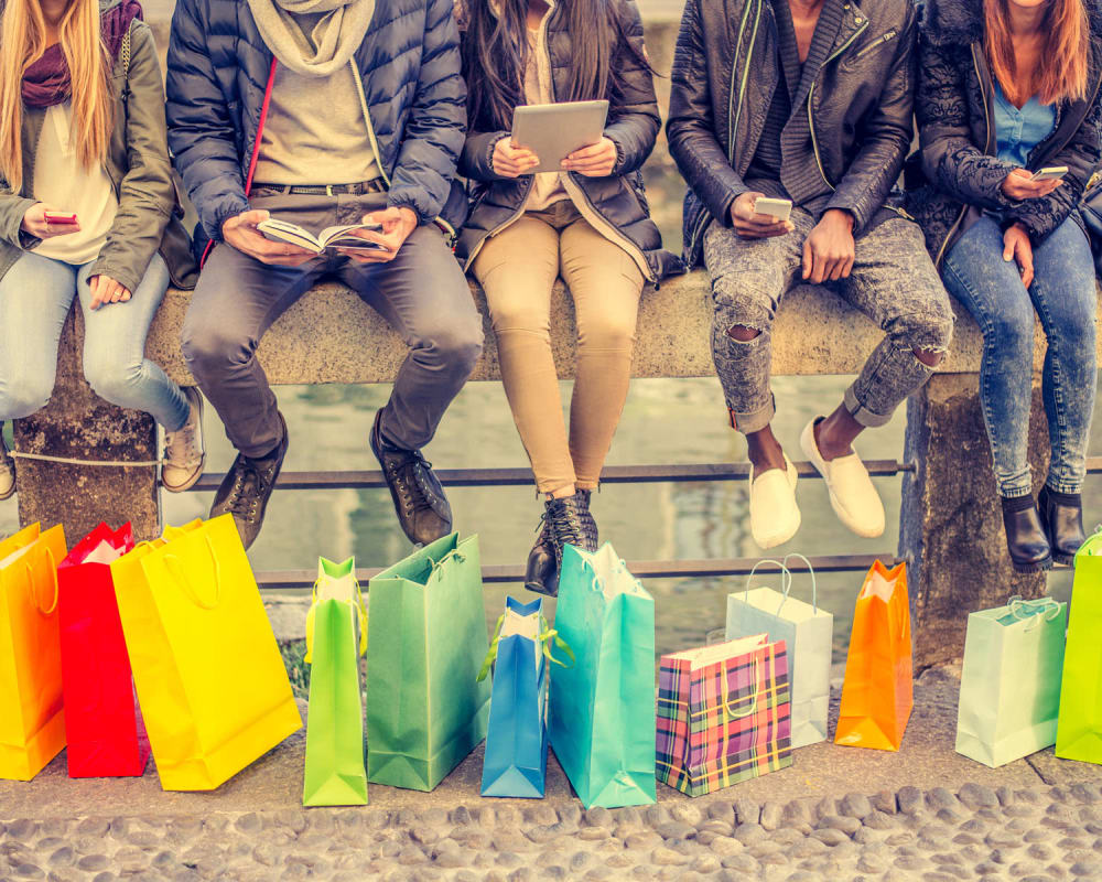 Friends with all their colorful shopping bags lined up together near Summerfield at Morgan Metro in Landover, Maryland