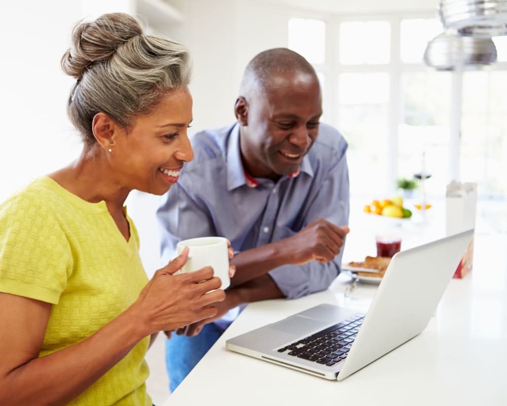 Residents chatting and looking at a laptop at Park Edge Apartments in Springfield, Massachusetts