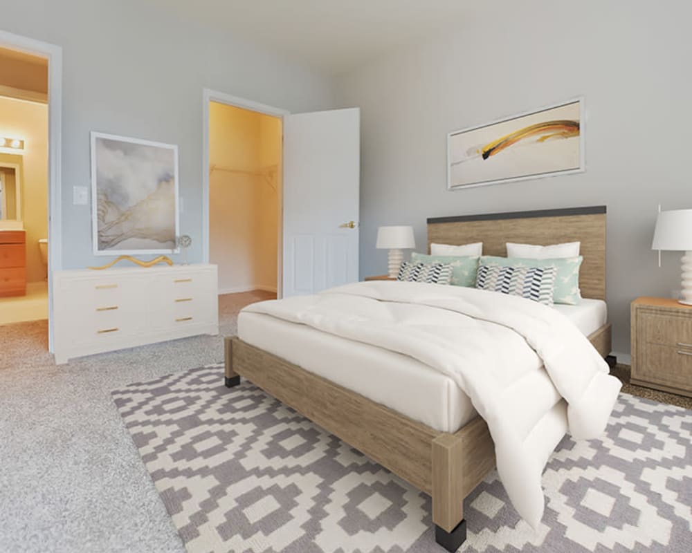 A bedroom with an attached bathroom and walk in closet in a home at Bishop's View Apartments & Townhomes in Cherry Hill, New Jersey