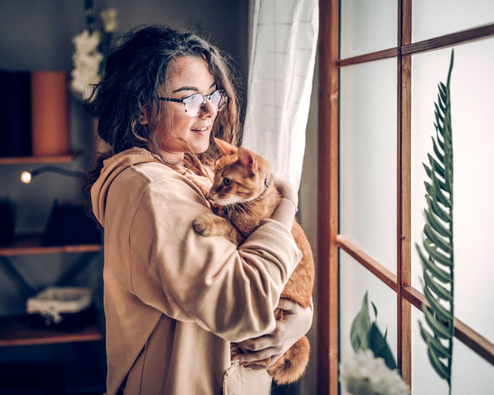 Resident holding her cat at Gull Harbor Apartments in New London, Connecticut