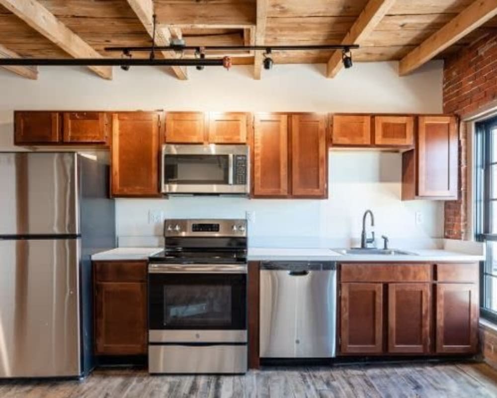 Kitchen with stainless steel appliance at Lofts at Cargill Falls Mill in Putnam, Connecticut