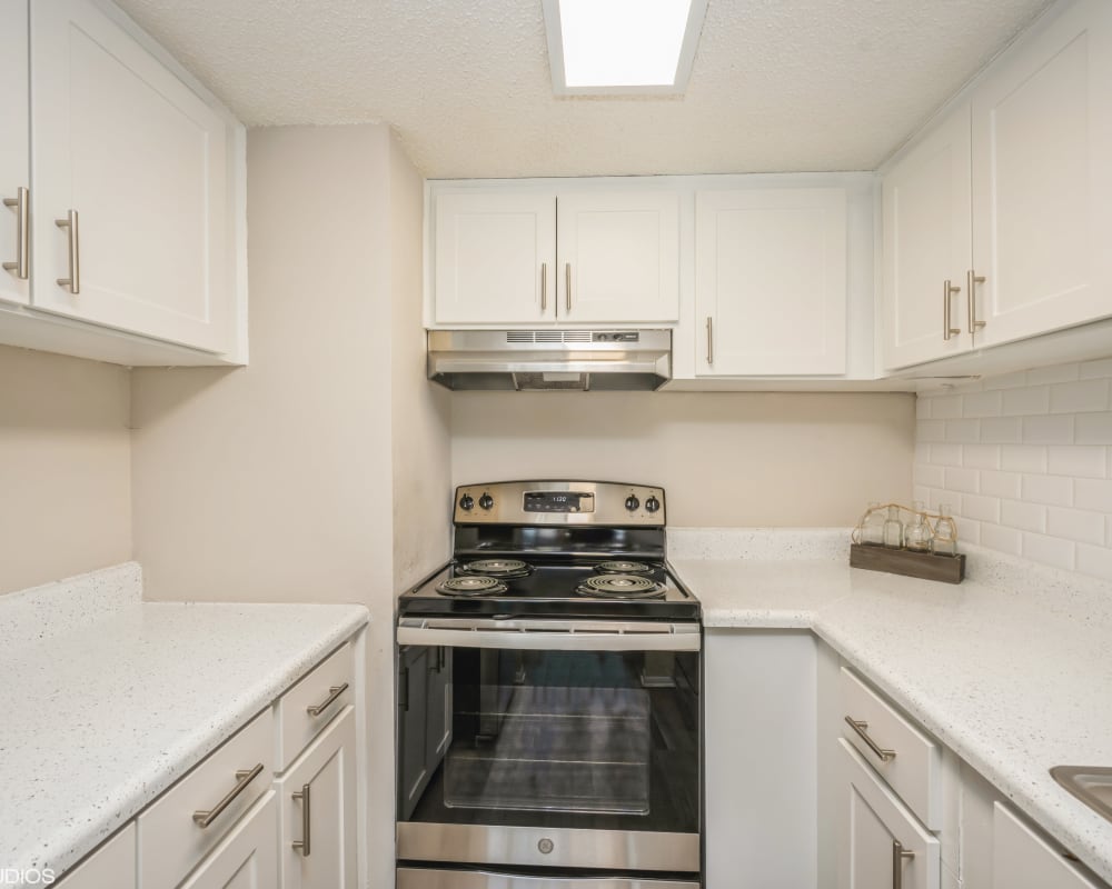 Stainless-steel sink with white appliances in model home at Grove at Temple Terrace in Temple Terrace, Florida