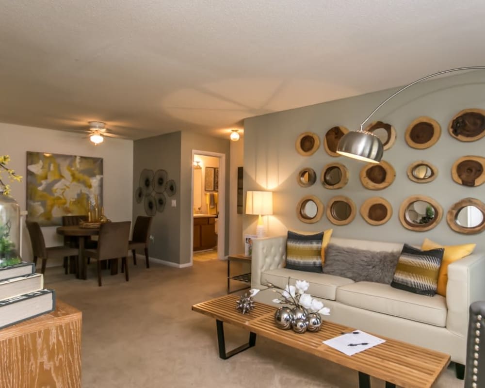 Spacious open concept living room and dining room in a model home at St. Andrews Commons Apartment Homes in Columbia, South Carolina