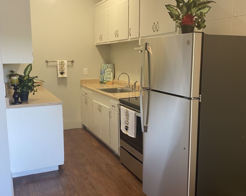 Model kitchen with wood flooring at Pennsylvania Apartments in Fremont, California