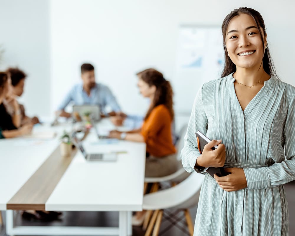 A smiling employee in an office at Allegiant-Carter Management in Tampa, Florida