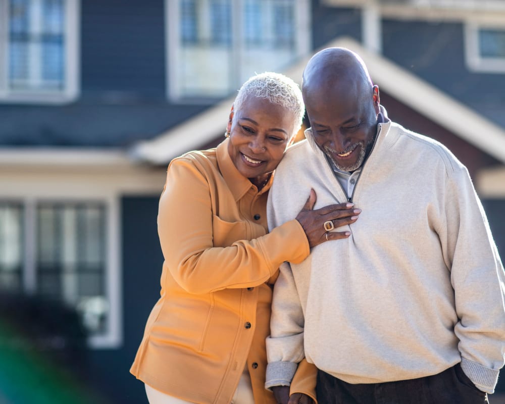 Senior couple standing together outside of a house at The Pillars of Lakeville in Lakeville, Minnesota