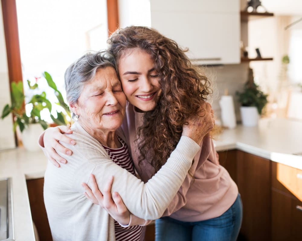 Resident hugging a family member at The Pillars of Lakeville in Lakeville, Minnesota