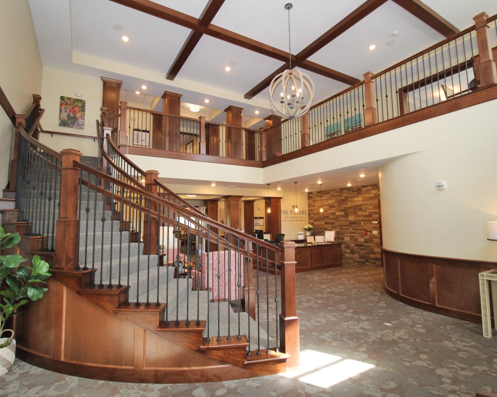 Main entrance and reception area with beautiful curved staircase at The Pillars of Mankato in Mankato, Minnesota