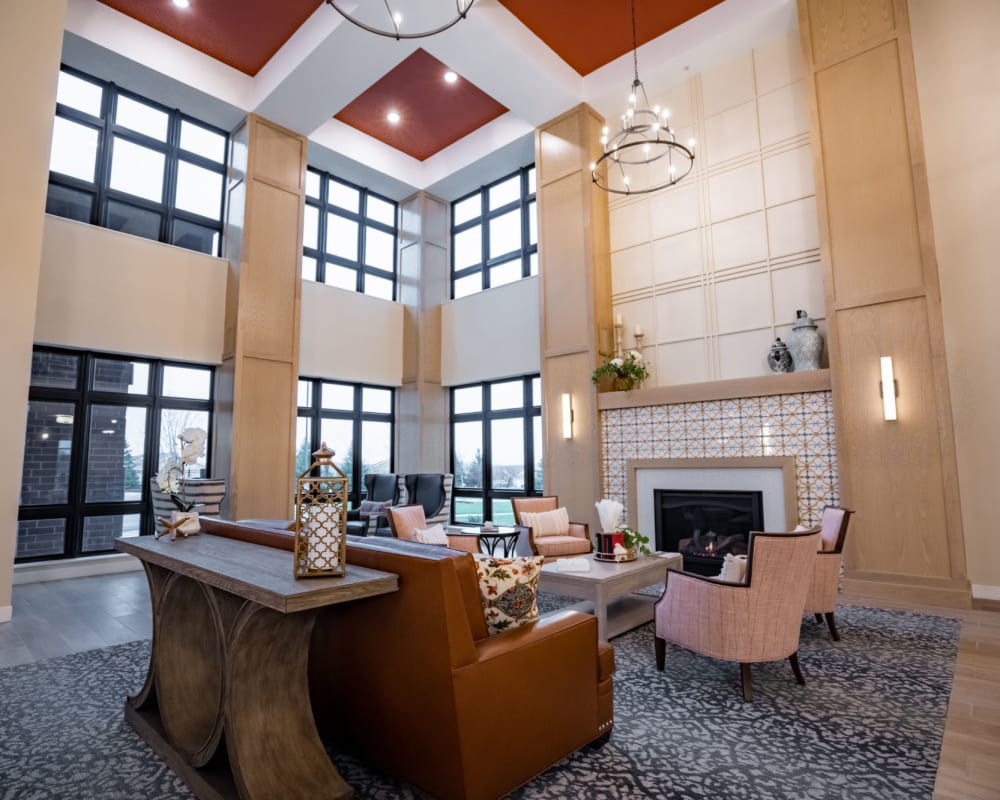 Main lobby and lounge area with seating and marble fireplace at The Pillars of Lakeville in Lakeville, Minnesota