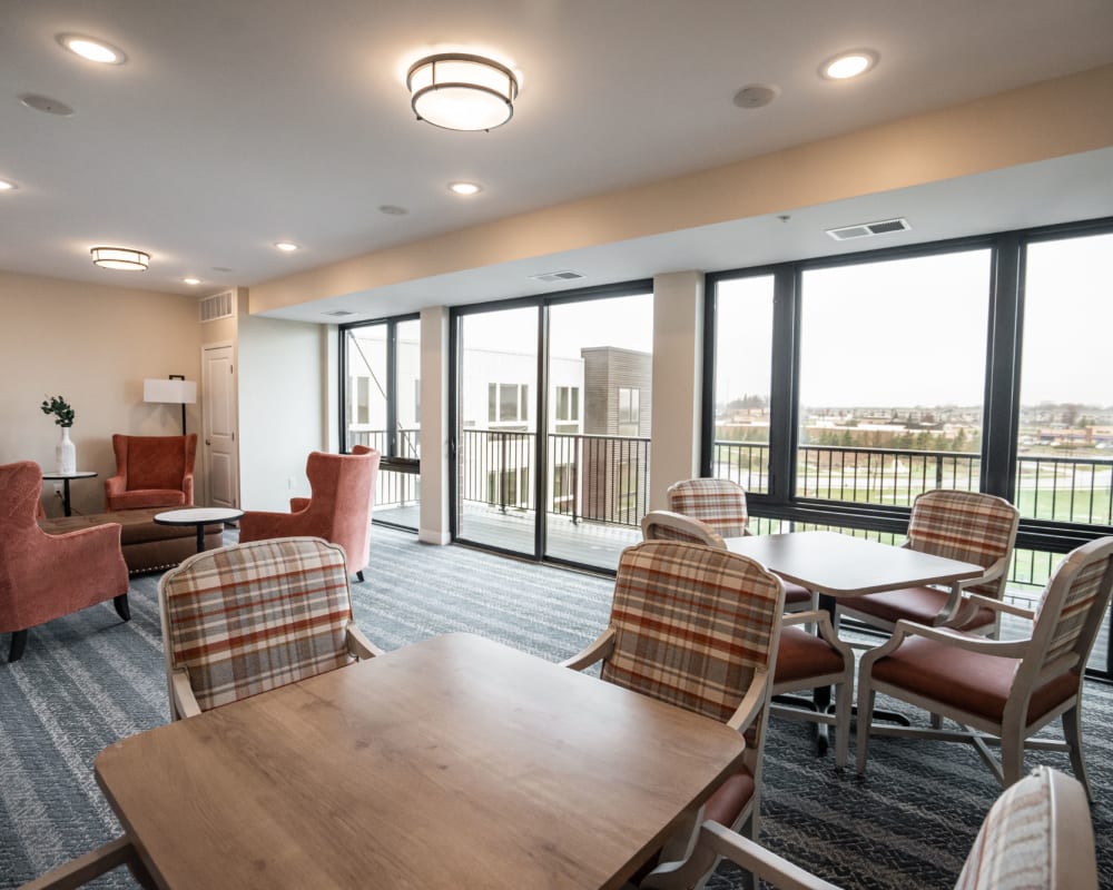 Resident dining space with multiple tables and chairs at The Pillars of Lakeville in Lakeville, Minnesota