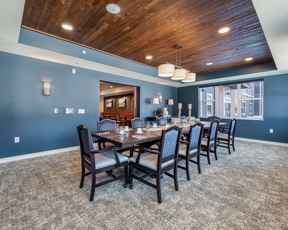 Private resident dining room with long dining room table at The Pillars of Grand Rapids in Grand Rapids, Minnesota