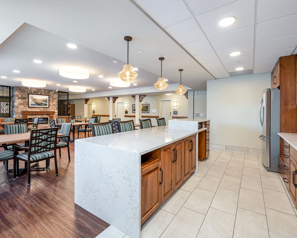 Resident dining area with stainless steel appliances at The Pillars of Grand Rapids in Grand Rapids, Minnesota